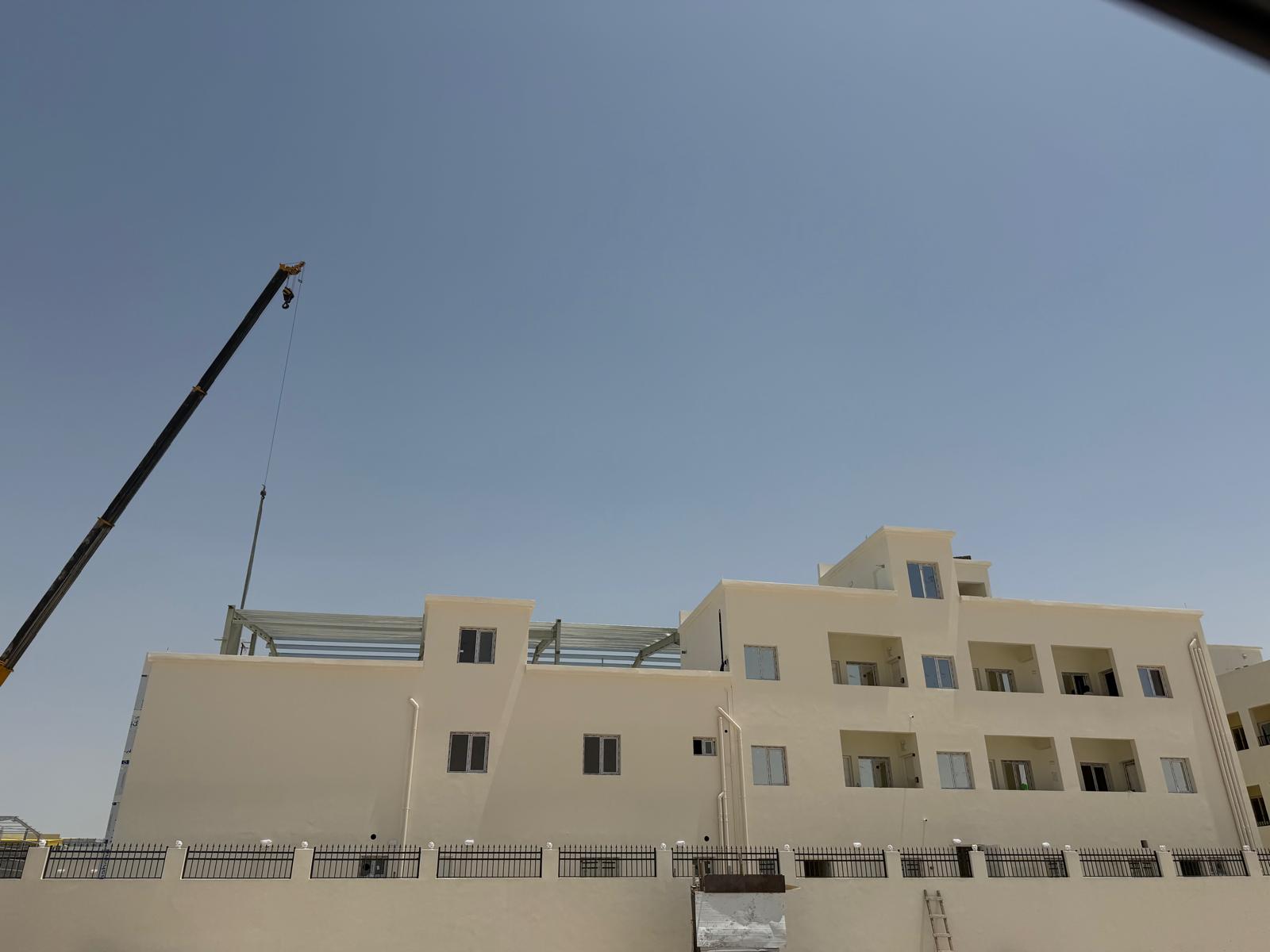 Three-story staff accommodation block at Birkat Al Awamer